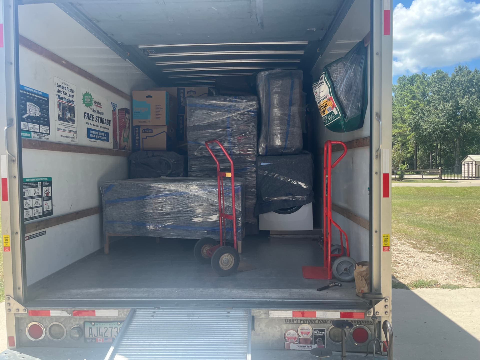 Wrapped and padded furniture with hand trucks inside the loaded truck