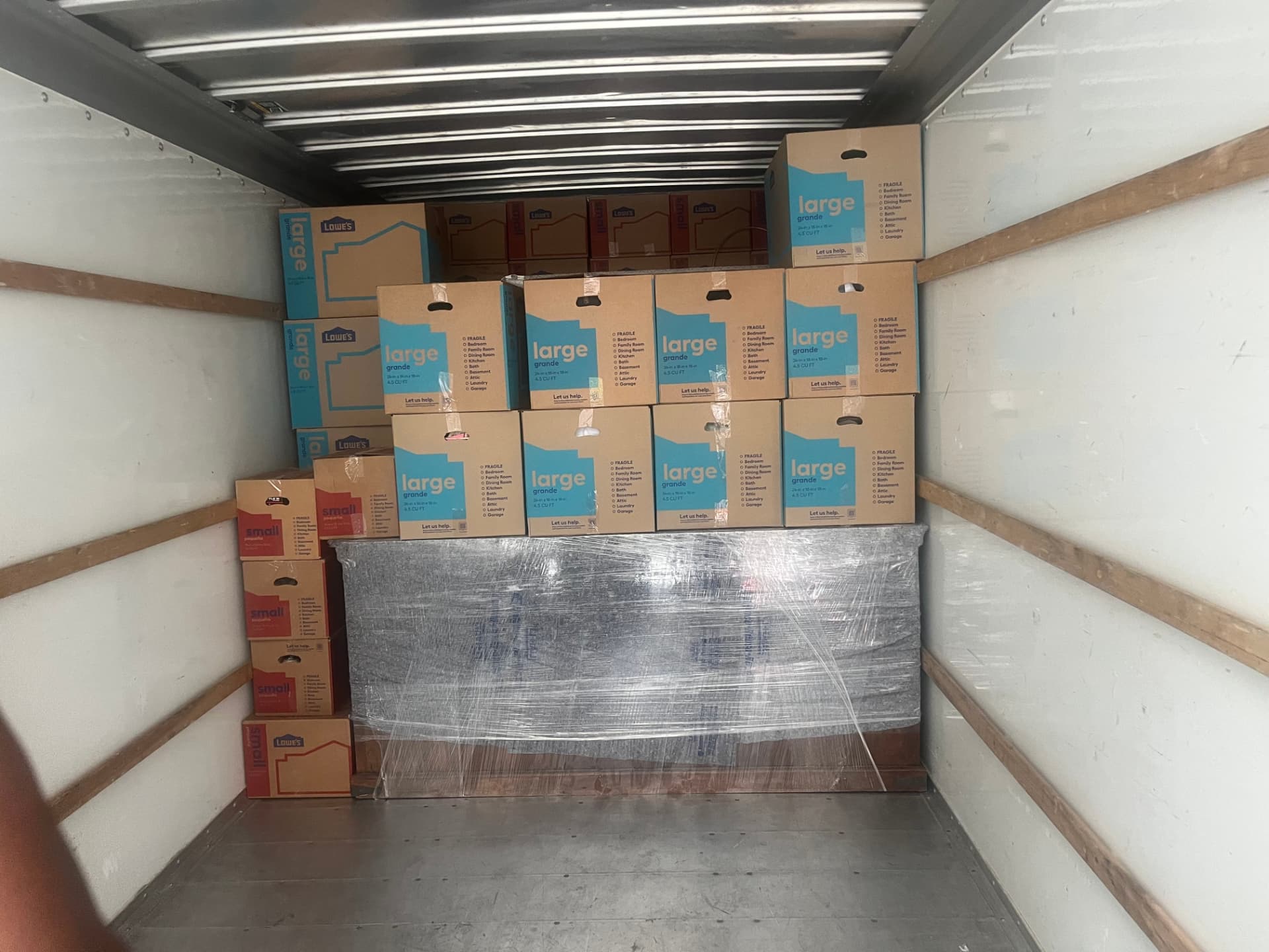Moving boxes stacked floor to ceiling inside the box truck