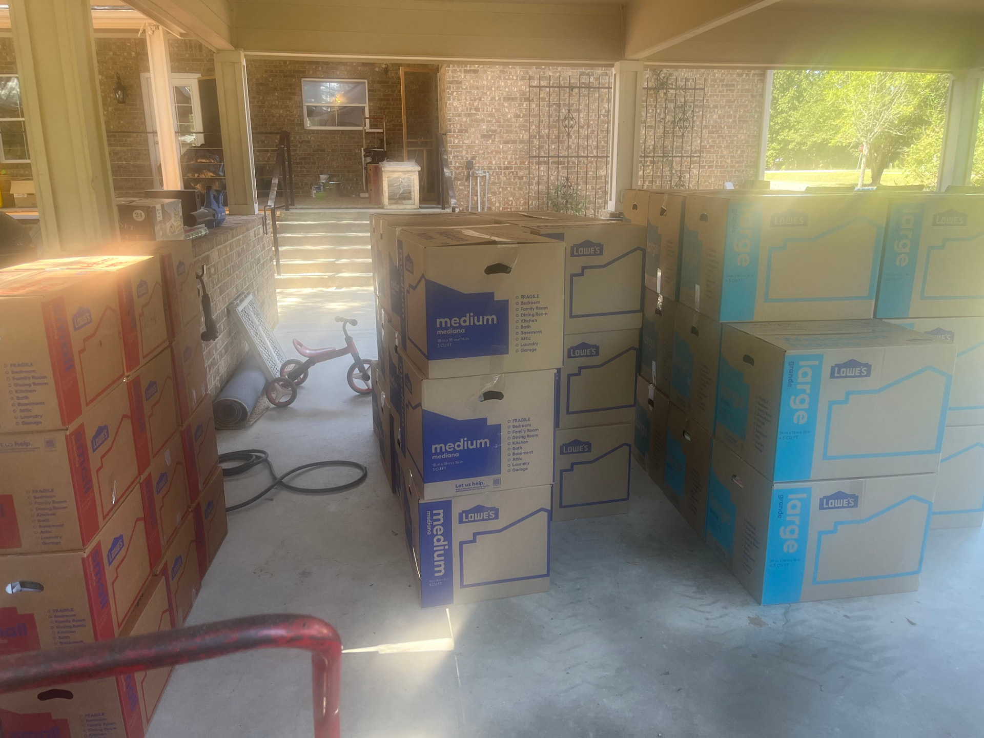 Boxes packed and staged on a covered patio before loading