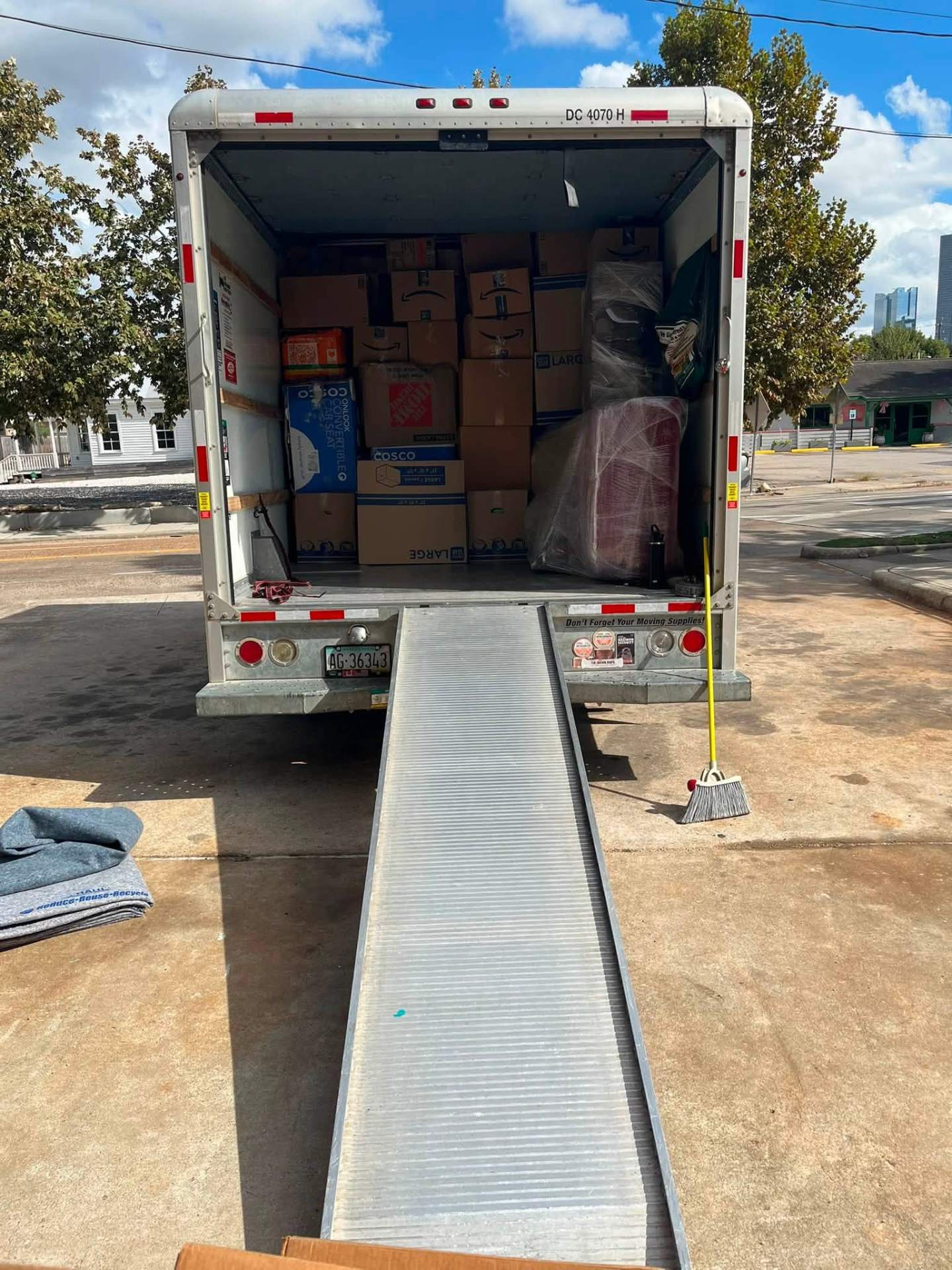 Full box truck with ramp down at a Houston delivery